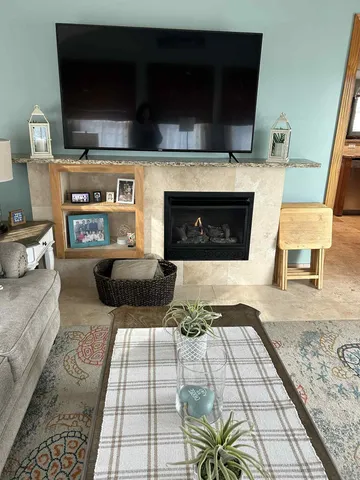 a living room with furniture and a fireplace