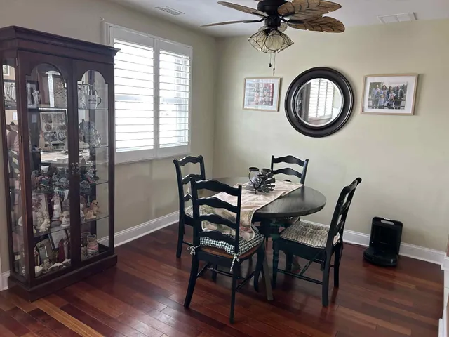a view of a dining room with furniture and a window