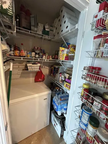 a utility room with dryer washer and shoe rack