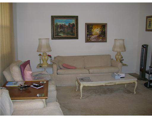 447 Saxony Way, Unit 447 Delray Beach, FL 33446 - Photo 2 of 7 a living room with furniture and a flat screen tv