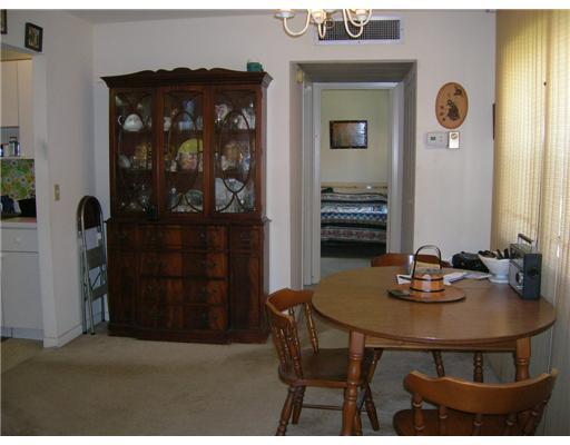 447 Saxony Way, Unit 447 Delray Beach, FL 33446 - Photo 3 of 7 a dining room with a table and chairs