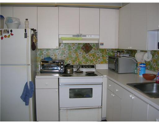 447 Saxony Way, Unit 447 Delray Beach, FL 33446 - Photo 4 of 7 a kitchen with a sink a stove and cabinets