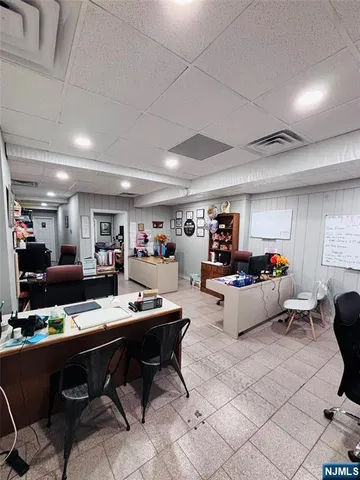 a living room with furniture kitchen view and a large window