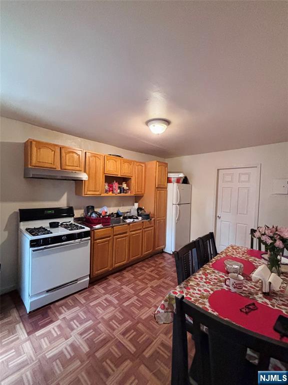 36 Cianci Street Paterson, NJ 07501 - Photo 9 of 9 a kitchen with stainless steel appliances granite countertop a stove a sink dishwasher and a refrigerator with wooden floor