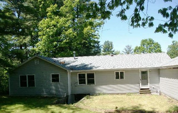 91 Groton School Road Ayer, MA 01432 - Photo 3 of 11 a backyard of a house with yard and outdoor seating