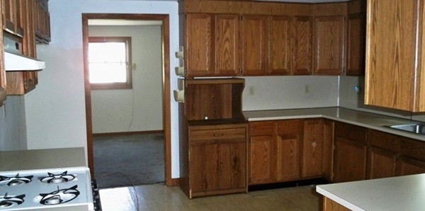 91 Groton School Road Ayer, MA 01432 - Photo 4 of 11 a kitchen with a refrigerator and cabinets