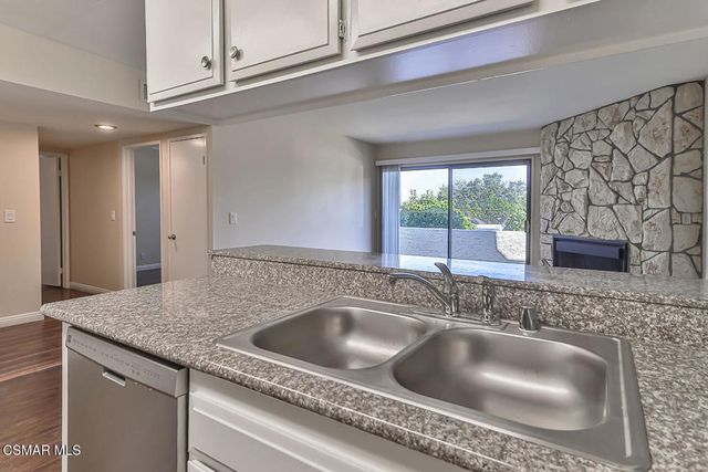 a kitchen with stainless steel appliances white cabinets and a refrigerator