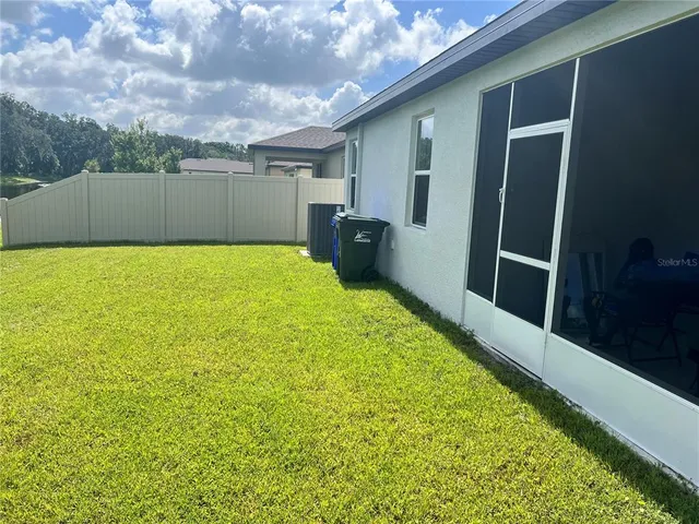 a bathroom with a large window and walk in closet