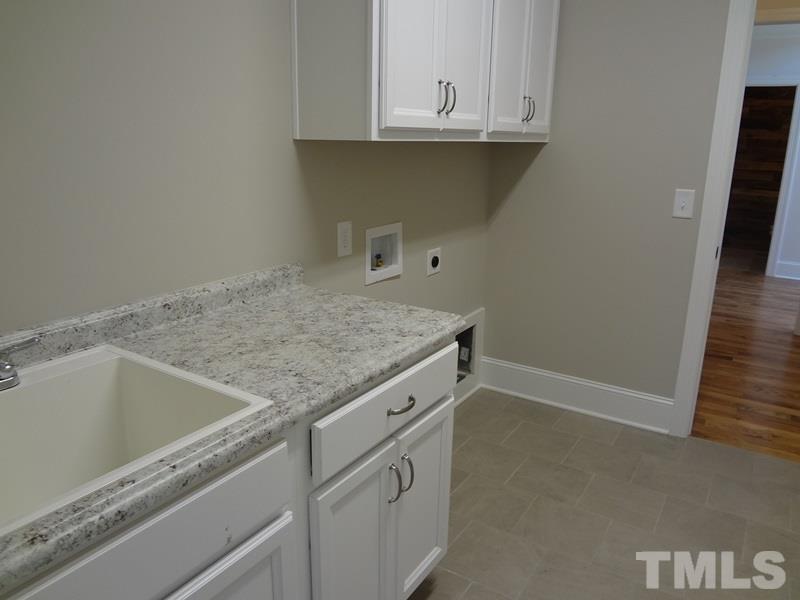 13800 Durant Road Raleigh, NC 27614 - Photo 22 of 25 a kitchen with granite countertop white cabinets and a sink