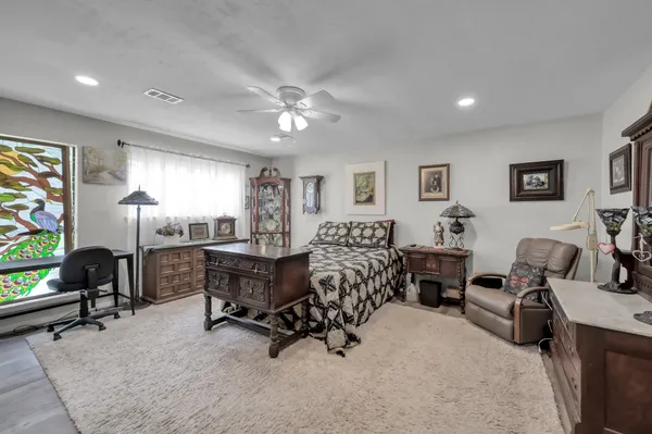 a bedroom with bed furniture and window