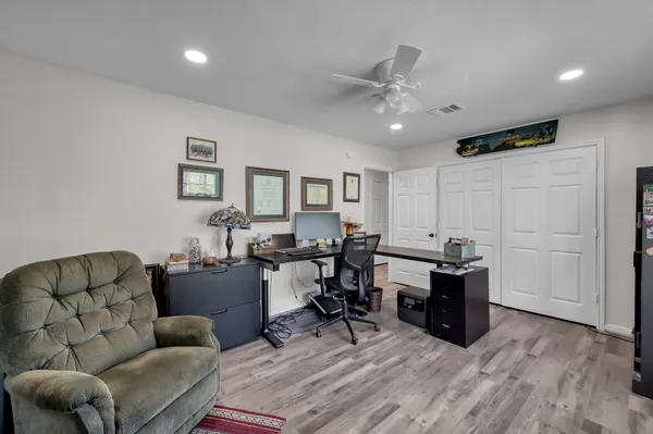 a spacious bathroom with a toilet a sink and a mirror