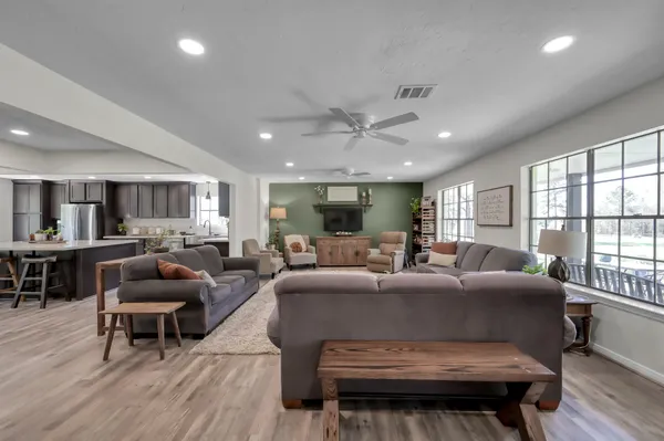 a bathroom with a granite countertop sink a toilet and a mirror
