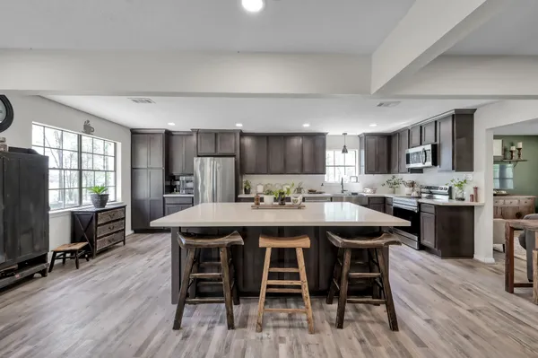 a view of a workspace with furniture and wooden floor