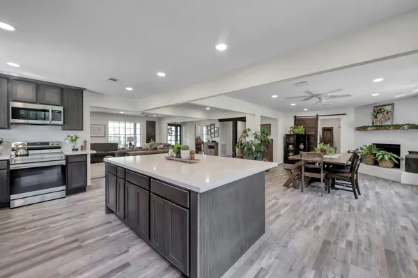 a spacious bedroom with a bed a couch and potted plant