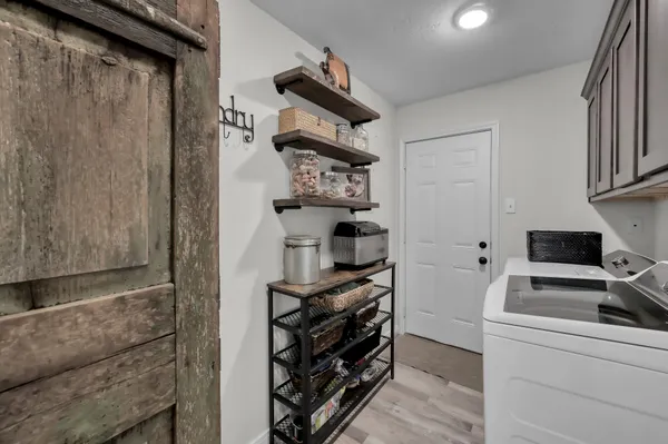 a spacious bathroom with a granite countertop sink and a mirror