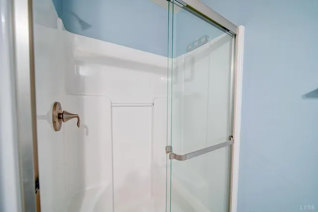 a bathroom with a glass shower door