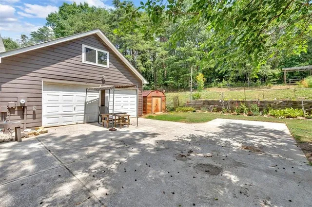 a view of a house with backyard and a tree