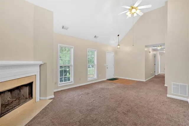 a view of empty room with a fireplace