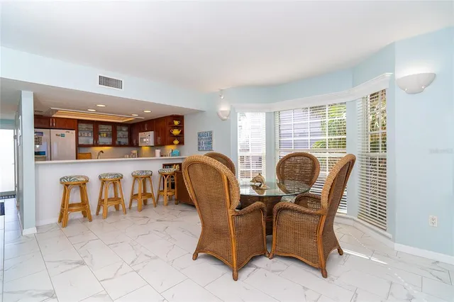 a dining room with furniture and chandelier