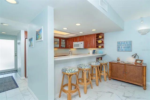 a kitchen with a sink and chairs