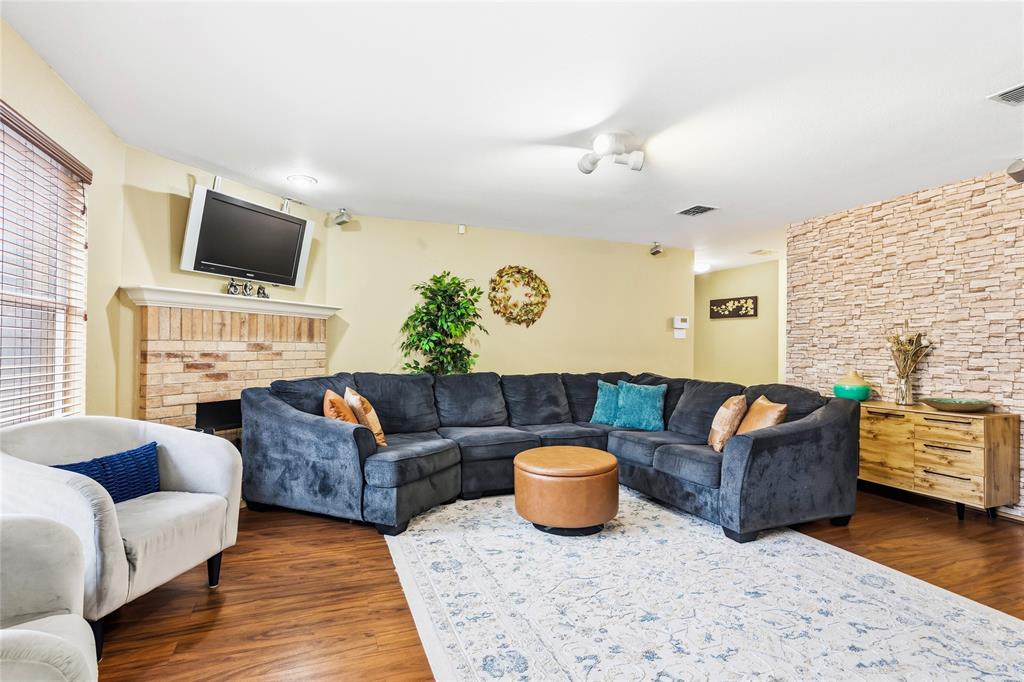 2701 Rudder Lane McKinney, TX 75071 - Photo 3 of 21 Open concept living room with faux brick wall covering