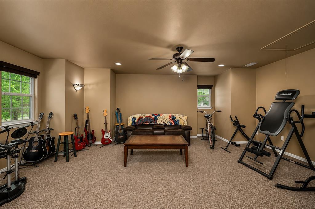 100 Manders Court Runaway Bay, TX 76426 - Photo 21 of 33 a living room with furniture gym equipment and a large window