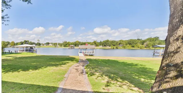 a view of a lake with houses in the back