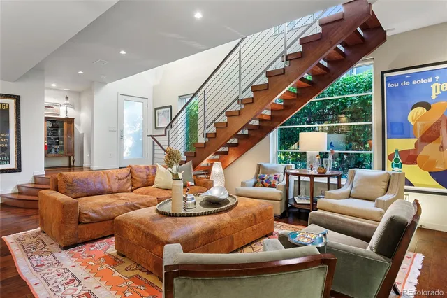 a living room with furniture and a floor to ceiling window