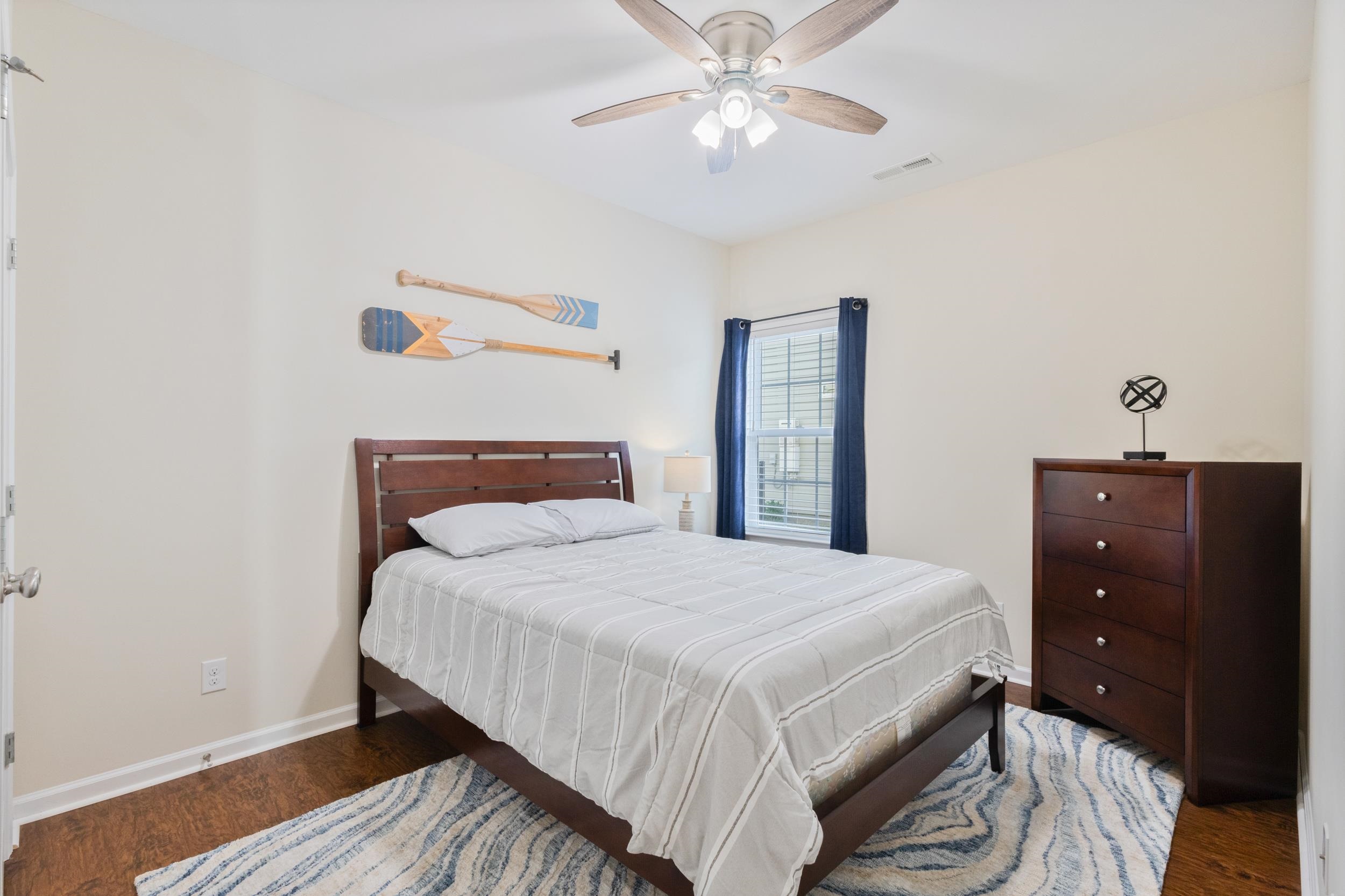 224 Obi Lane Surfside Beach, SC 29575 - Photo 12 of 24 Kitchen featuring stainless steel appliances, a center island with sink, dark wood-style flooring, vaulted ceiling, and a breakfast bar
