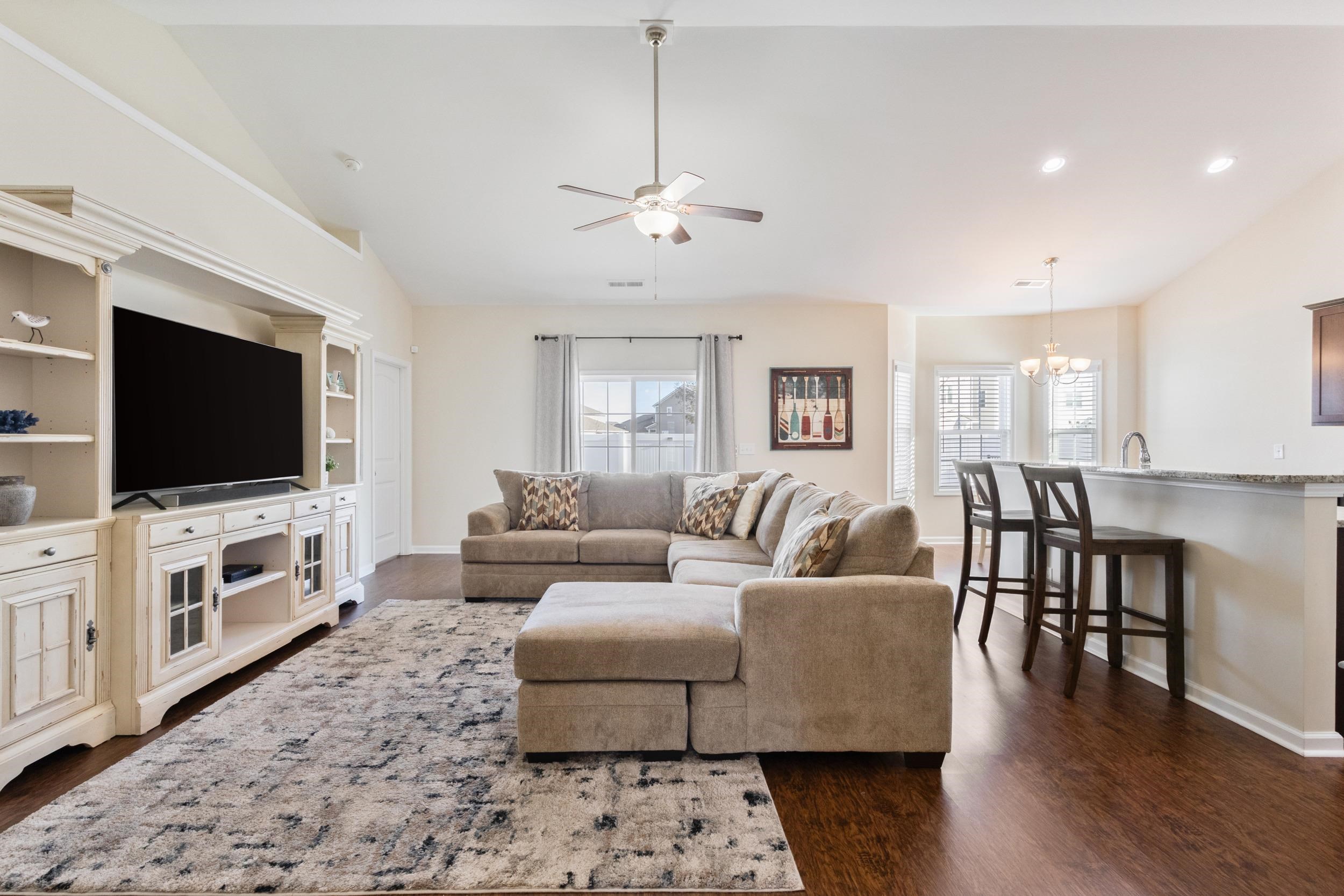 224 Obi Lane Surfside Beach, SC 29575 - Photo 4 of 24 Living room featuring ceiling fan, dark wood-type flooring, a chandelier, high vaulted ceiling, and recessed lighting
