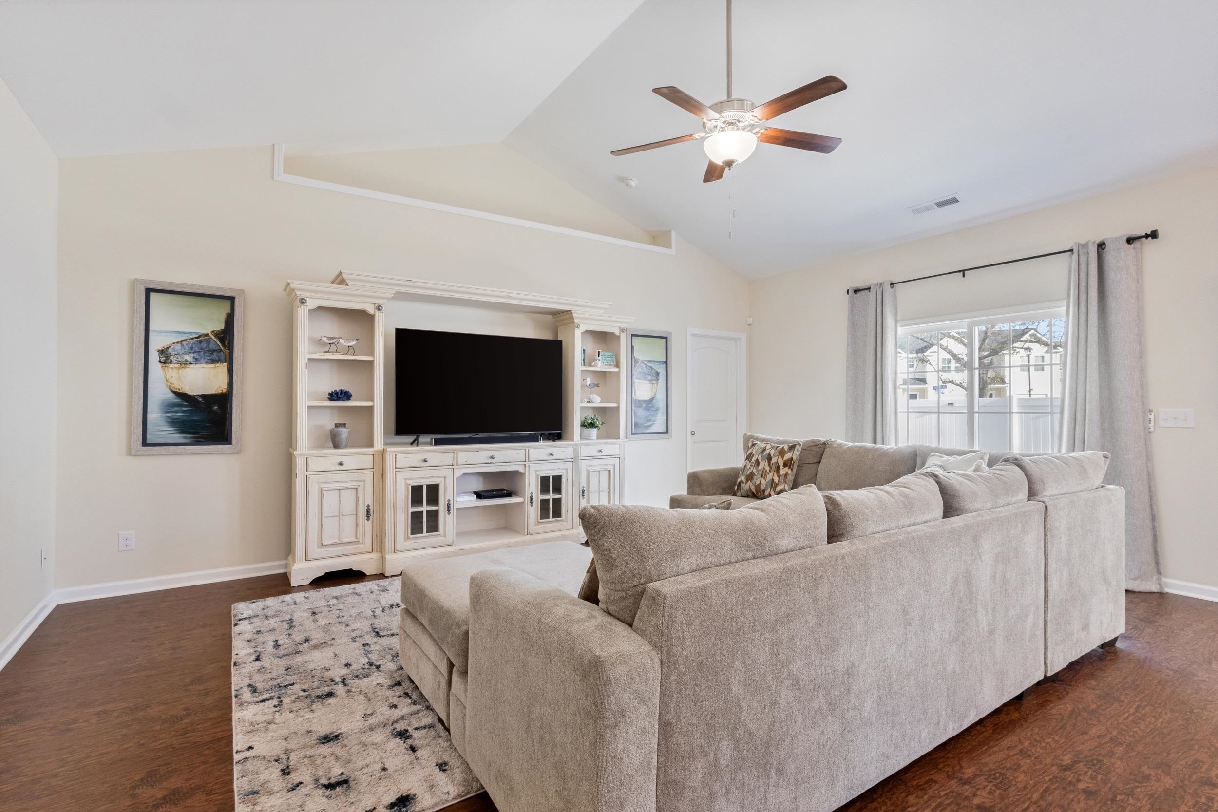224 Obi Lane Surfside Beach, SC 29575 - Photo 5 of 24 Living room featuring dark wood-type flooring, ceiling fan, and high vaulted ceiling