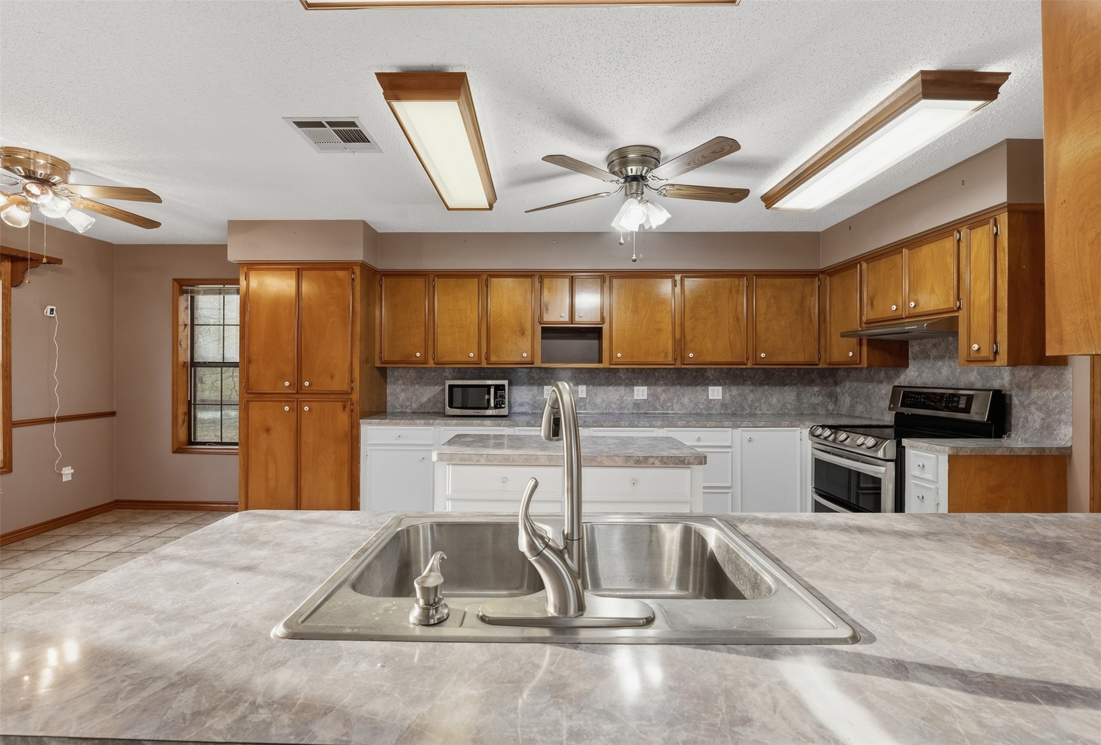200 Cove View Drive Trinity, TX 75862 - Photo 6 of 39 a kitchen with kitchen island a counter top space appliances and a cabinets