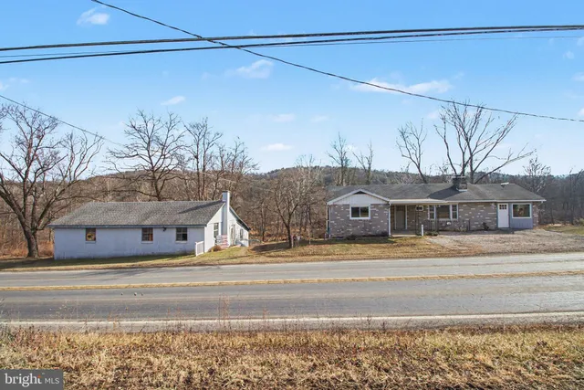 a view of a house with a snow on the road