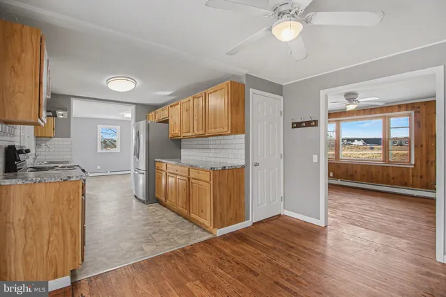 a view of a kitchen cabinets and wooden floor