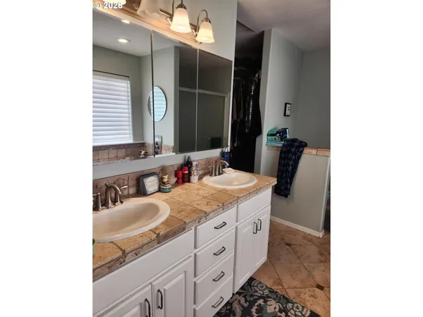 a bathroom with a sink double vanity and a mirror