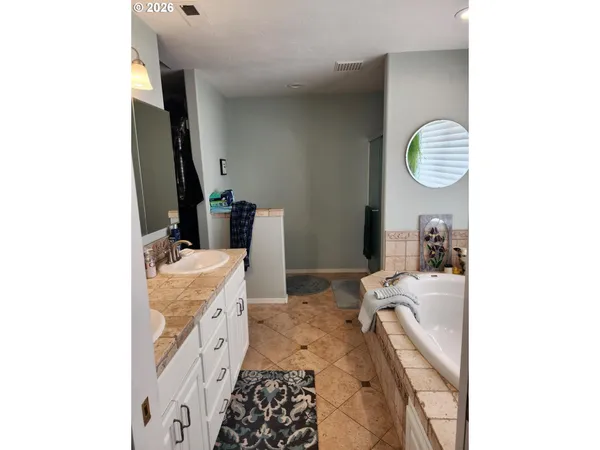a bedroom with bed and wooden floor