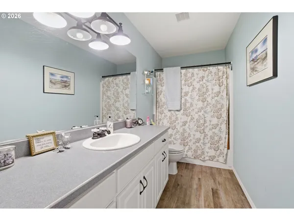 a bathroom with a sink a mirror and a shower