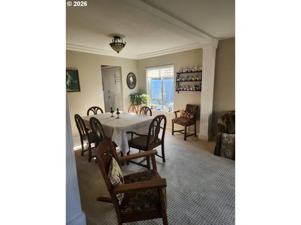 a view of a dining room with furniture and a window