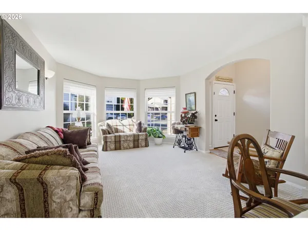 a living room with furniture a couch and dresser