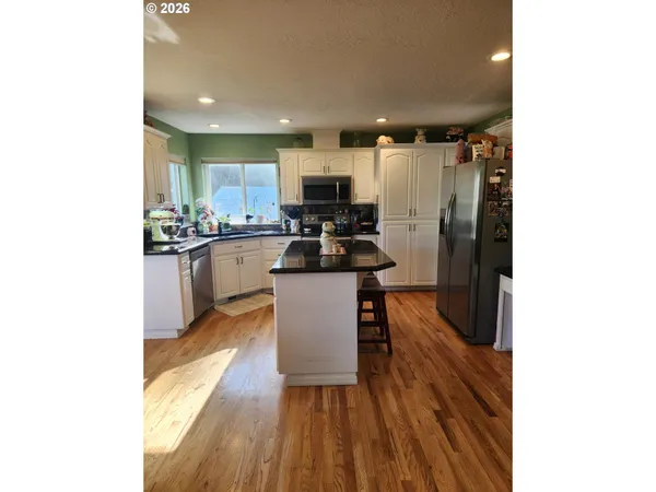 a kitchen with a sink cabinets and stainless steel appliances