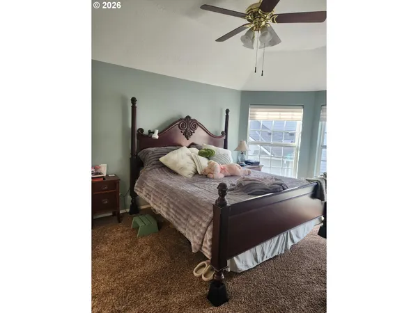 a bed sitting in a bedroom next to a window