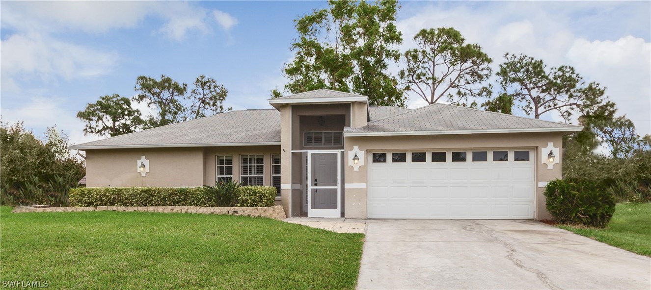 17373 Butler Road Fort Myers, FL 33967 - Photo 1 of 20 a front view of a house with a garden