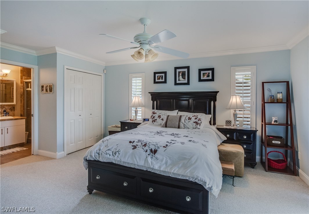 17373 Butler Road Fort Myers, FL 33967 - Photo 11 of 20 a bedroom with a bed and a chandelier