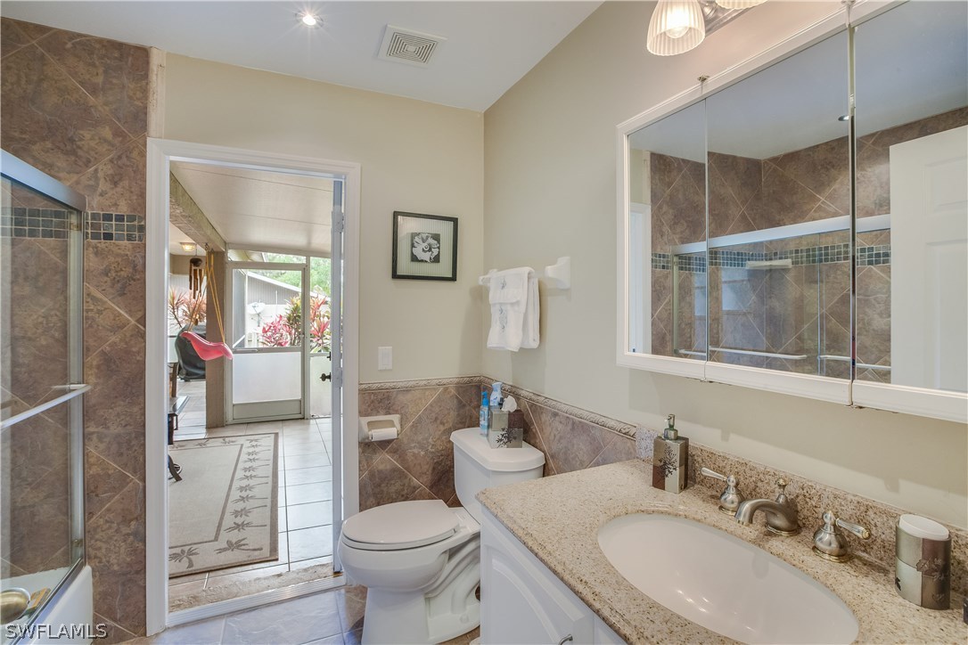 17373 Butler Road Fort Myers, FL 33967 - Photo 15 of 20 a bathroom with a granite countertop sink toilet and shower