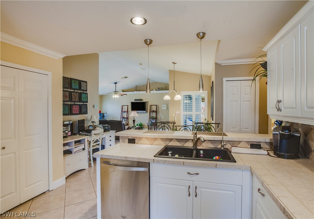 17373 Butler Road Fort Myers, FL 33967 - Photo 10 of 20 a kitchen with a sink stove and cabinets