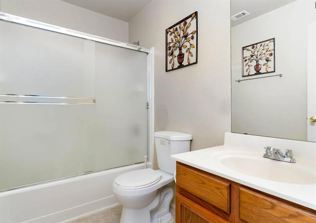 2743 Cold Water Trail Grand Prairie, TX 75052 - Photo 11 of 20 a bathroom with a sink a toilet and shower