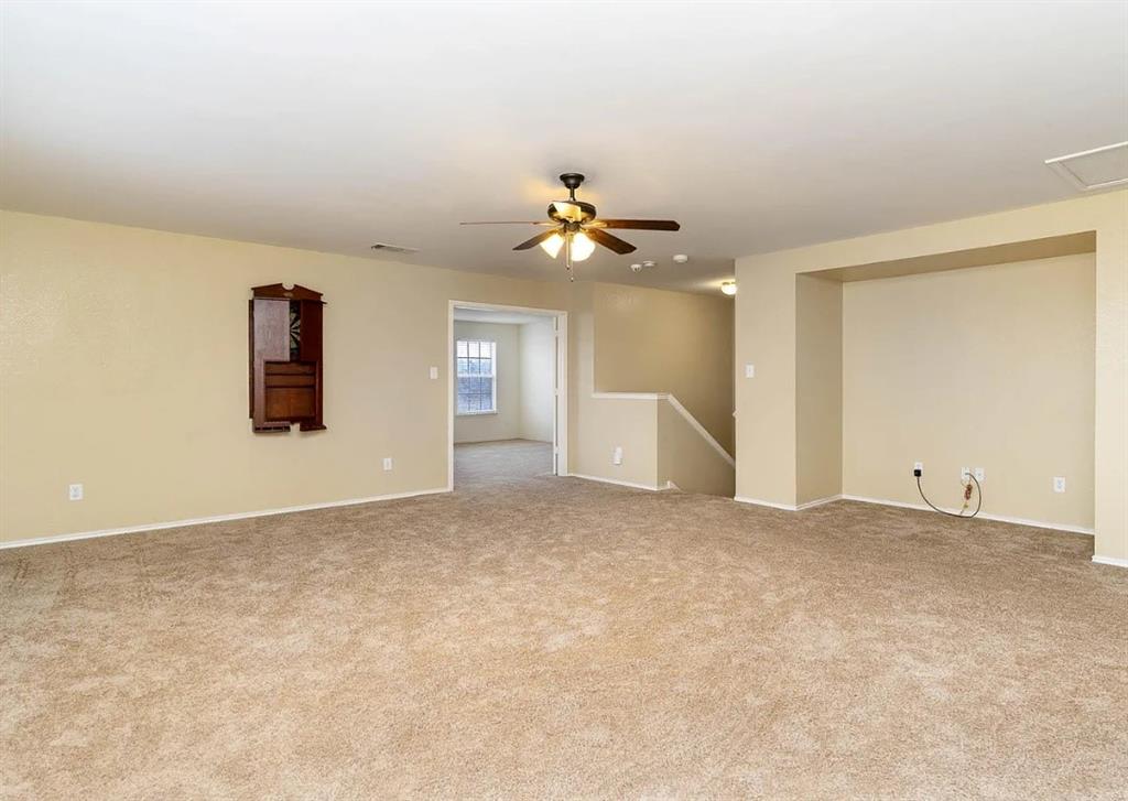 2743 Cold Water Trail Grand Prairie, TX 75052 - Photo 13 of 20 an empty room with windows and a ceiling fan