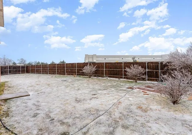 a view of a backyard with floor to ceiling windows and sky view