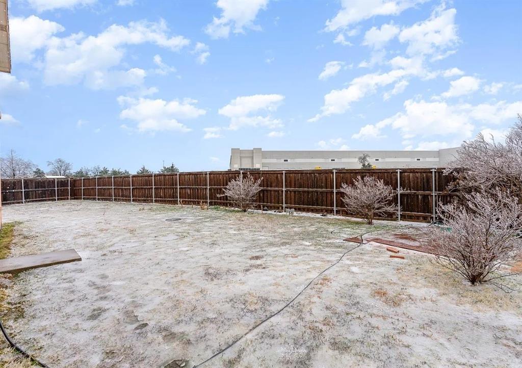 2743 Cold Water Trail Grand Prairie, TX 75052 - Photo 19 of 20 a view of a backyard with floor to ceiling windows and sky view