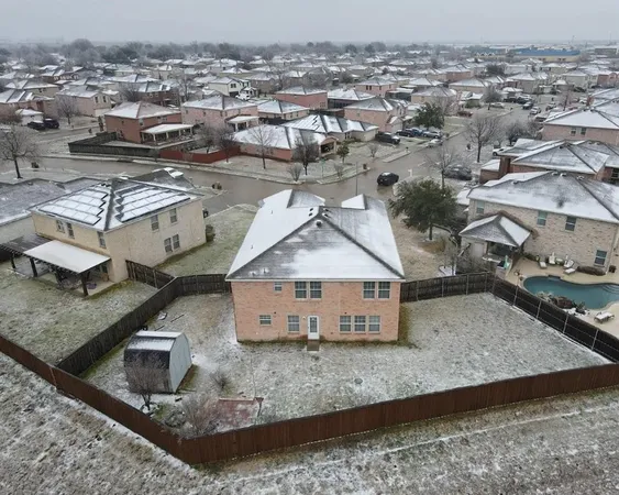 an aerial view of a house with a yard and lake view